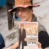 Kocher displays a book he rented from the New York Public Library. An activist who has appeared in federal court for occupying a tree sit, Kocher describes himself as "a democratic globalist," and thinks the world should switch to a resource based economy. "Scarcity itself is a myth," he says.